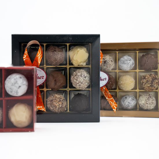 Drei geschlossene Prallinen Schachteln mit handgemachten Sahne-Trüffeln der Bäckerei-Konditorei Streicher