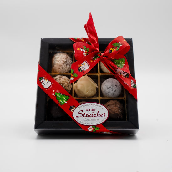 9 handgefüllte Sahne-Trüffel, gemischte Sorten. Verpackt in einer Schachtel mit Geschenkschlaufe.